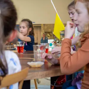 Children celebrate a birthday with lemonade, gift and decorations in the museum café during the children's party in the Shoe Quarter