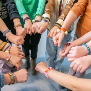 Children proudly display their bracelets they made during a workshop held during the children's festival in the Shoe Quarter