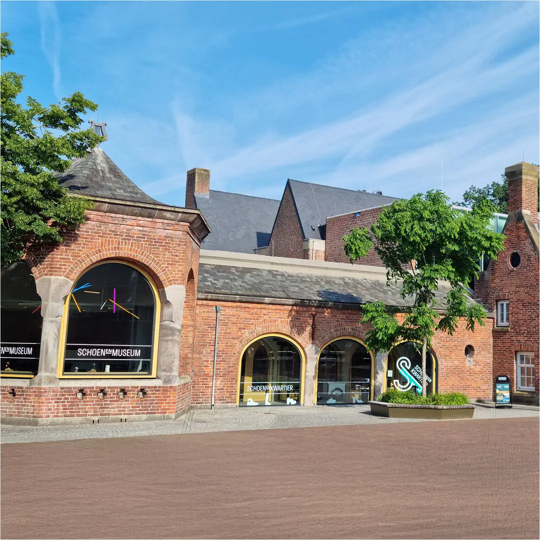 De buitengevel van het rijksmonumentale Krophollercomplex van het Schoenenkwartier aan het Raadhuisplein in Waalwijk, op een zonnige dag.